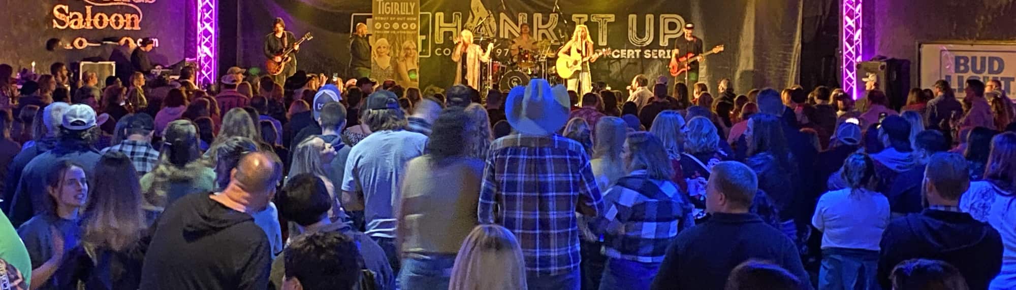 country concert with fans wearing cowboy hats Asheville